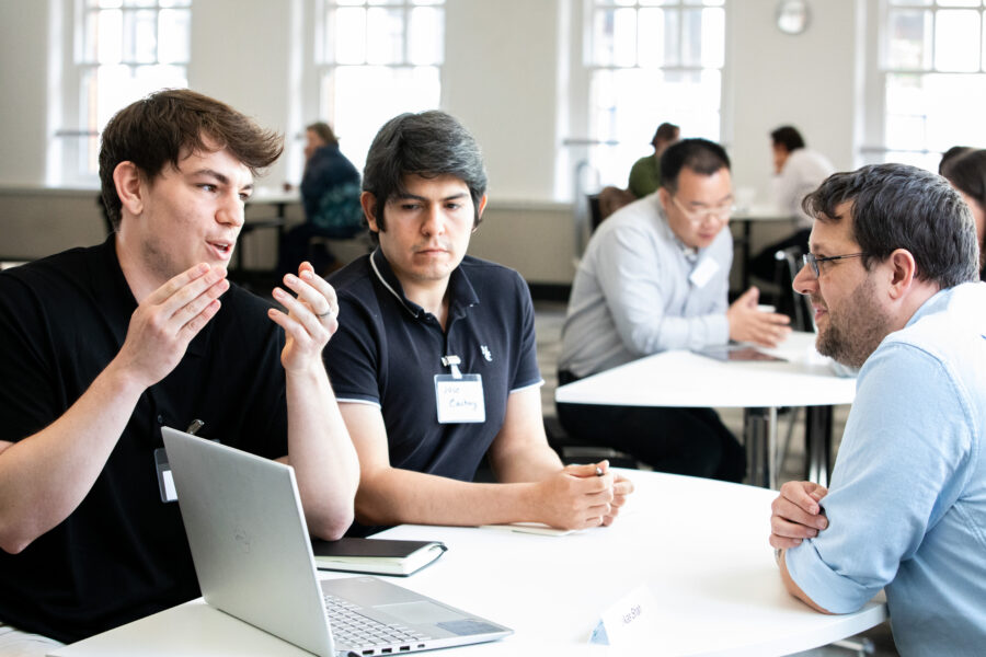 Two academics presenting their idea to a mentor